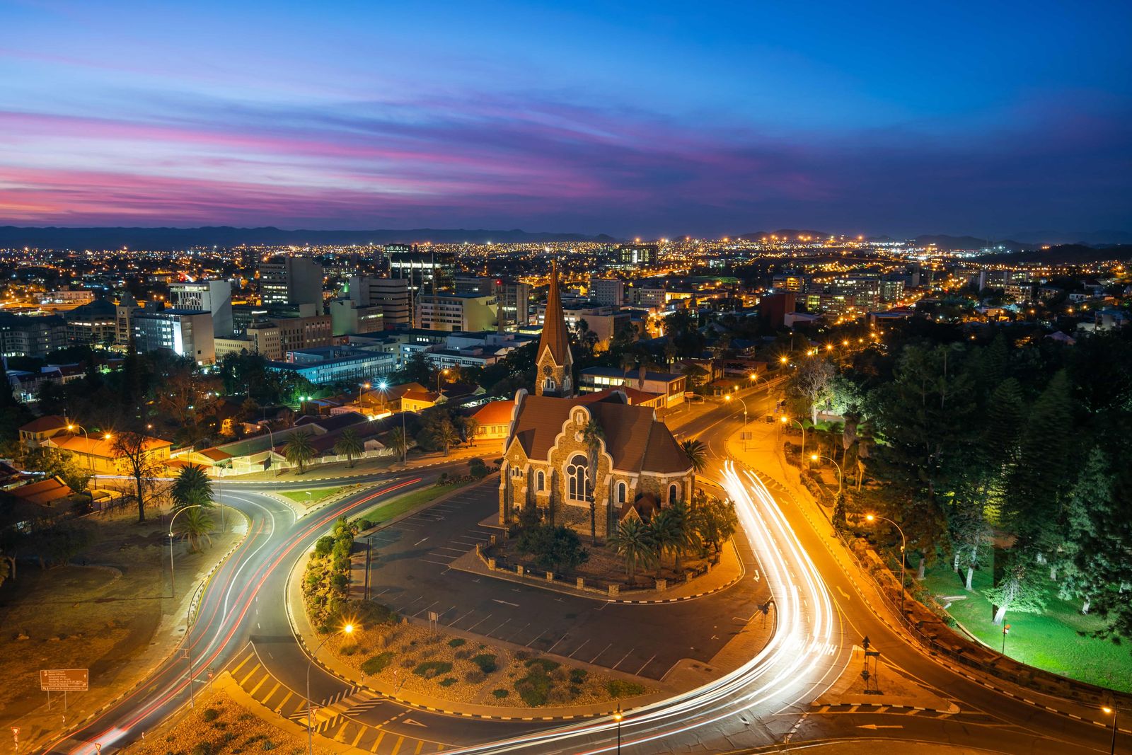 Windhoek skyline at dusk with the Christuskirche and light trails from traffic
